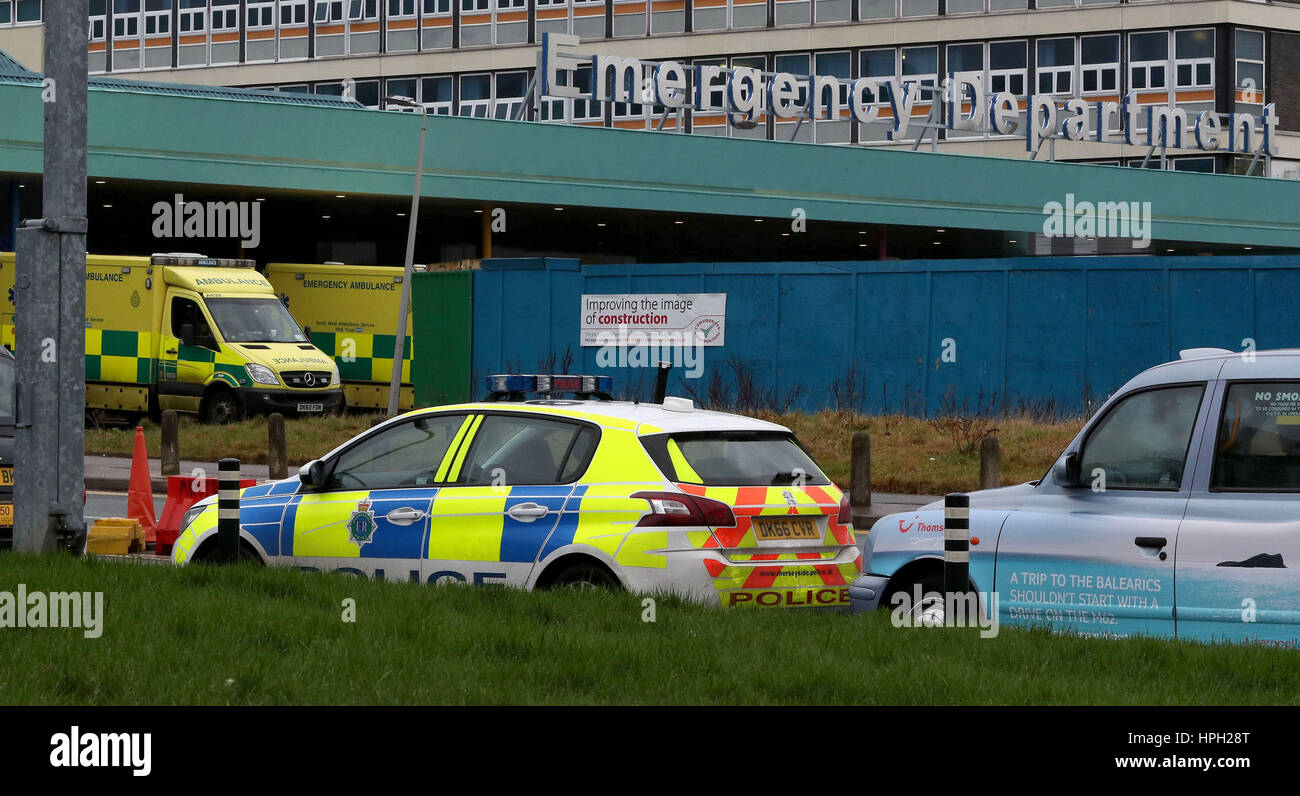 A police car is parked outside Aintree University Hospital in Liverpool, close to where murderer Shaun Colin Walmsley, who was jailed for a minimum of 30 years, fled after two armed men ambushed the car he was travelling in during an escorted visit to the hospital. Stock Photo