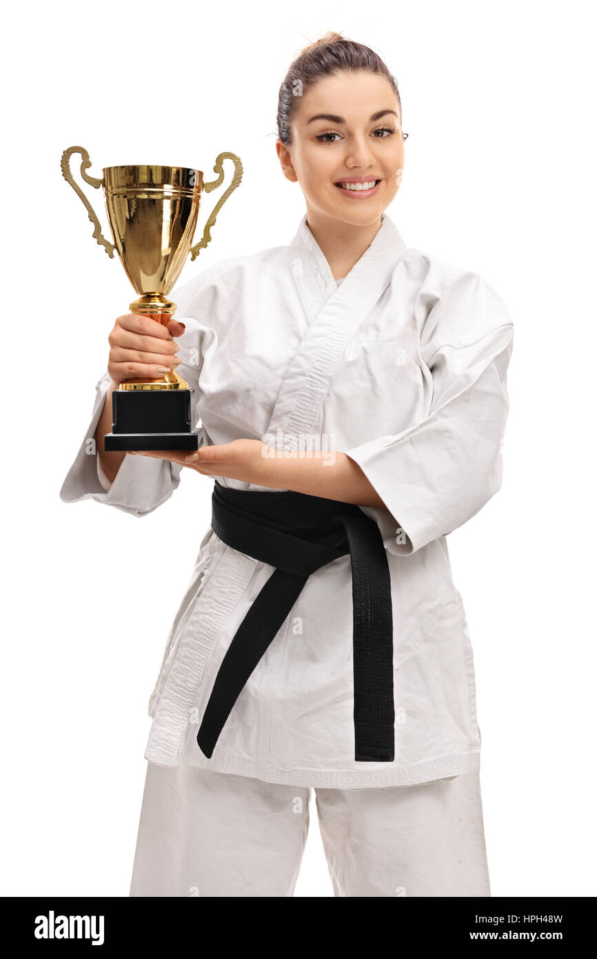 Joyful girl in a kimono holding a golden trophy isolated on white background Stock Photo