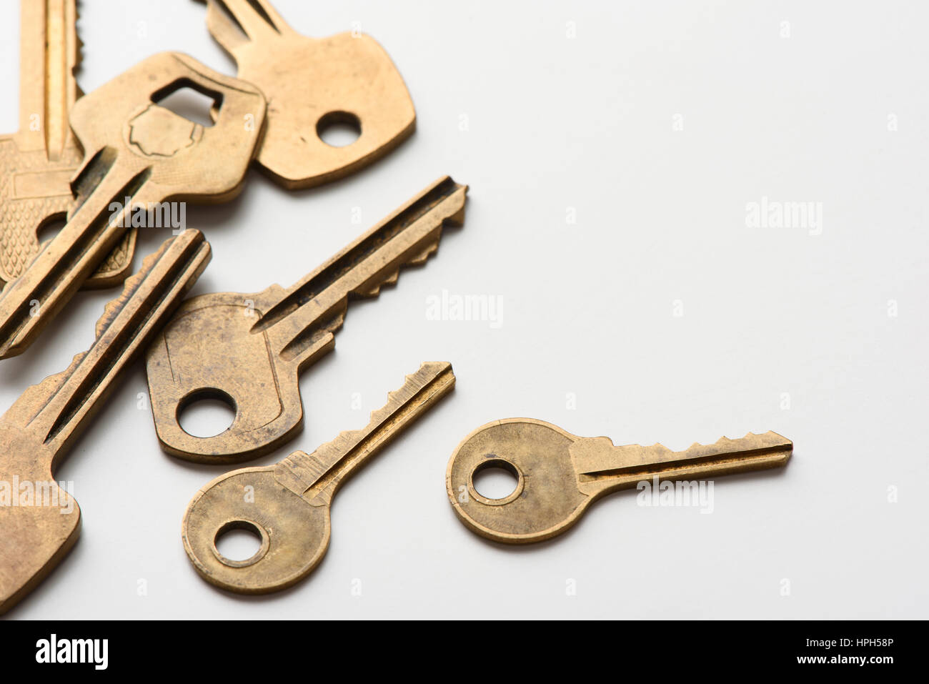 old brass keys on a white background Stock Photo - Alamy