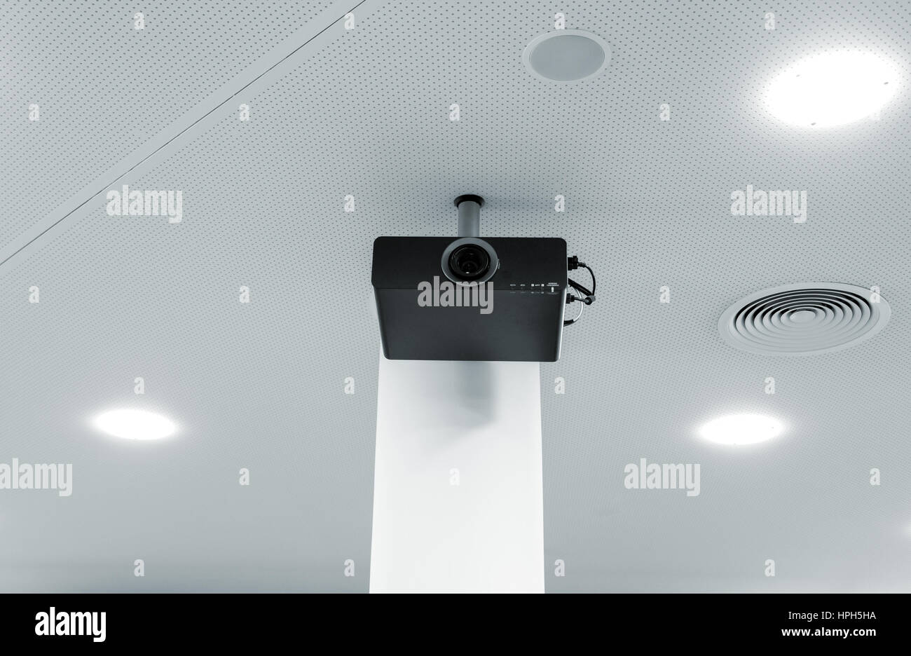 Multimedia Projector Hanging On The Ceiling Of Modern Conference