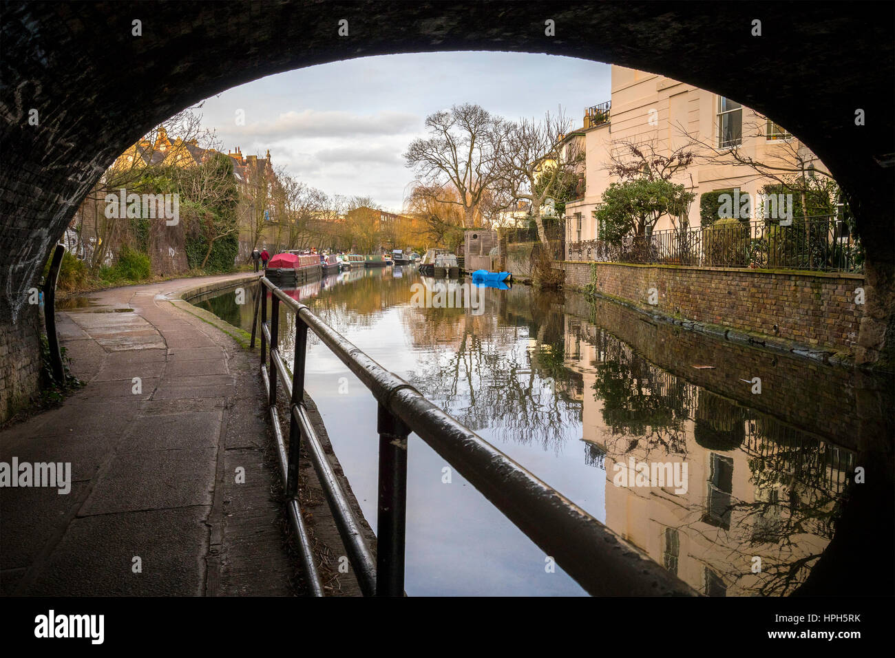 A british river canal with a bridge and house boats in the banks Stock