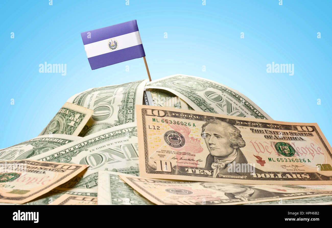 The national flag of El Salvador sticking in a pile of american dollars.(series) Stock Photo