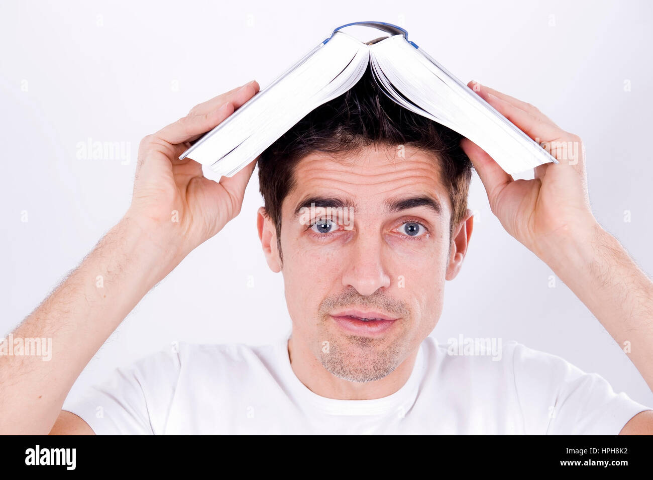 Mann mit Buch am Kopf - man with a book on head, Model released Stock Photo