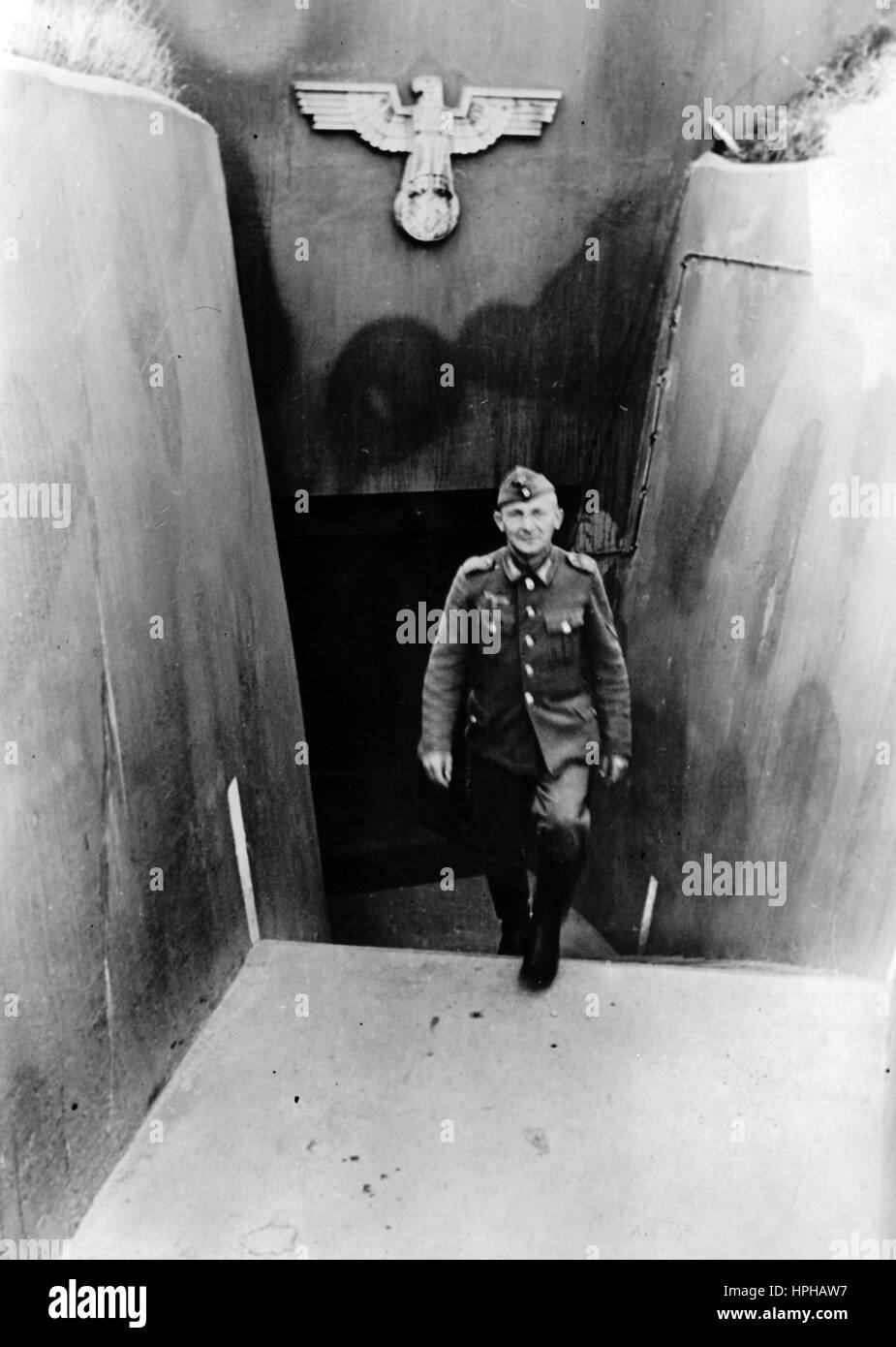 The Nazi propaganda image shows a German Wehrmacht soldier at the entrance to a fortified bunker on the Atlantic Wall in Heligoland. Published in January 1944. Fotoarchiv für Zeitgeschichte - NO WIRE SERVICE - | usage worldwide Stock Photo