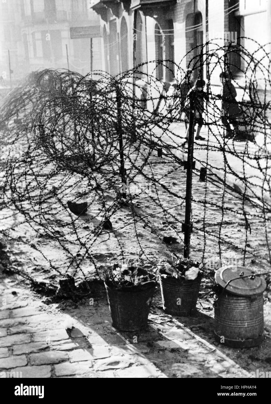 The Nazi propaganda image shows children playing behind barbed wire in a town on the French Channel coast during the German occupation. Published around 1943. A Nazi reporter has written on the reverse of the picture, 'Despite everything, life continues here at its normal pace. Barbed wire is the now the norm in a town on the Channel coast. The residents got used it a long time ago. Not even the game of these children is being seriously impeded by the obstacle.' Fotoarchiv für Zeitgeschichtee - NO WIRE SERVICE - | usage worldwide Stock Photo