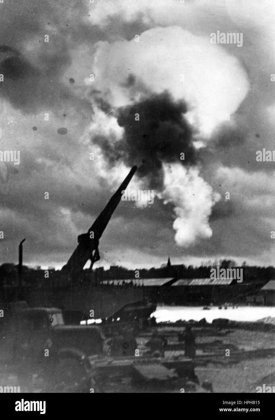 The Nazi propaganda image shows a German Wehrmacht heavy railway gun being fired on the Channel coast in occupied France. Published in January 1941. A Nazi reporter has written on the reverse of the picture, 'High in the sky, right on target. A railway gun being fired in the direction of England.' Fotoarchiv für Zeitgeschichte - NO WIRE SERVICE -  | usage worldwide Stock Photo