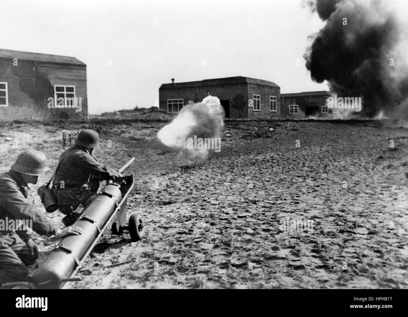 The Nazi propaganda image shows German Wehrmacht carrying out exercises with a flamethrower on the Atlantic Wall. Published in March 1944. A Nazi reporter has written on the reverse of the picture, "Flamethrowers on the Atlantic Wall. With all means of combat tried and tested year-round in the field, the crew of the large defensive fortifications on the Atlantic Wall are ready for an enemy attack. Exercises with flamethrowers in between bunkers. Dark, dense clouds spread over the area into which the deadly jet of fire is shot." Photo: Berliner Verlag/ Archive - NO WIRE SERVICE -  | usage world Stock Photo
