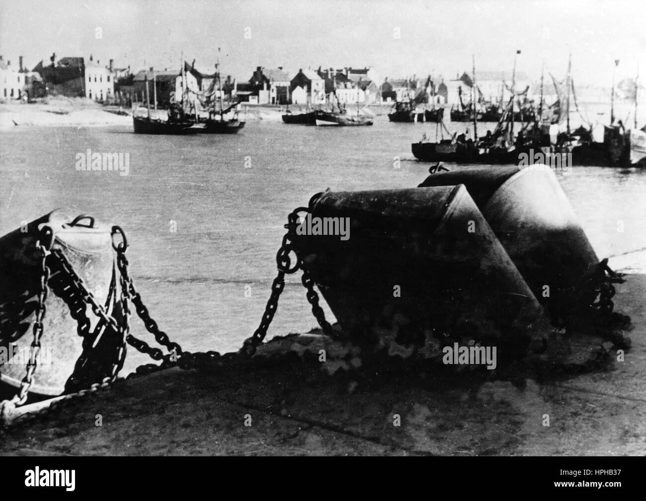 The Nazi propaganda image shows barrier chains at a local fishing port on the Atlantic Wall. Published in April 1944. A Nazi reporter has written on the reverse on 25.04.1944 'Precautions are taken everywhere. Even in the smallest fishing port barrier chains lie at the ready, waiting to make a entry or an invasion attempt impossible.' Fotoarchiv für Zeitgeschichte- NO WIRELESS SERVICE - | usage worldwide Stock Photo