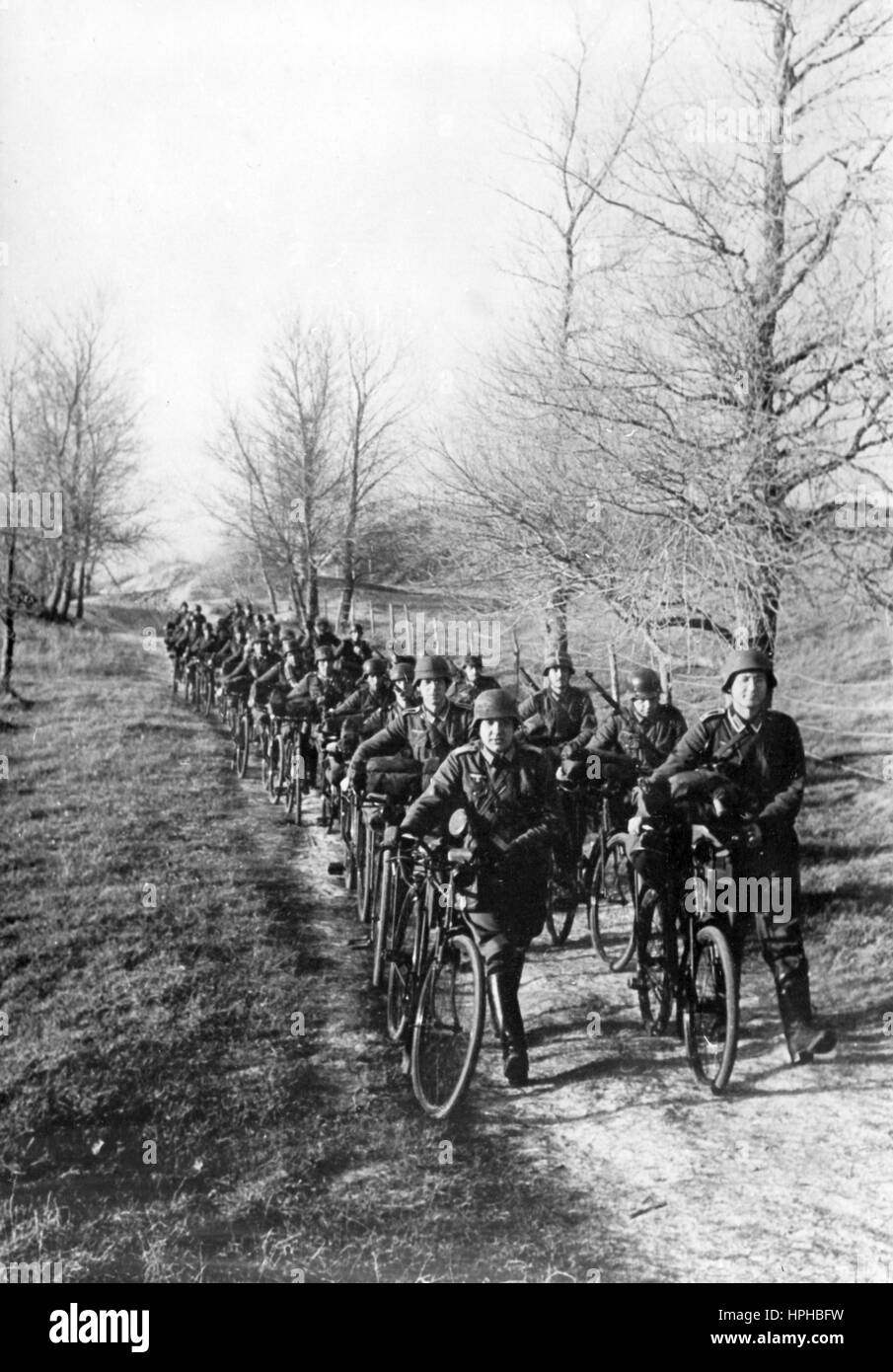 The Nazi propaganda image shows members of a German Wehrmacht bicycle  infantry unit during an exercise on the West Front. Published in January  1941. A Nazi reporter has written on the reverse