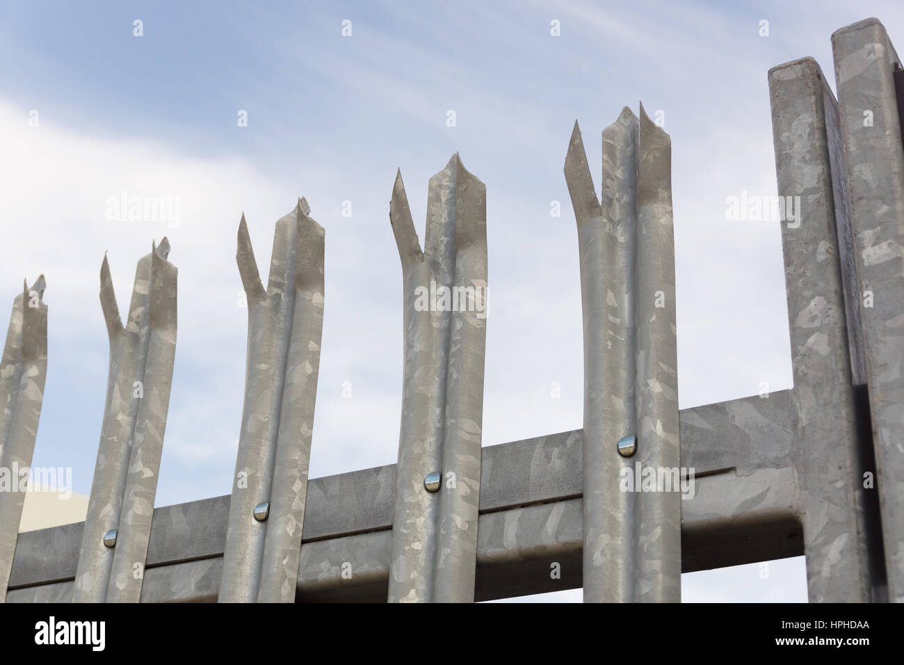Galvanised steel spikes on top of a security gate or fence Stock Photo
