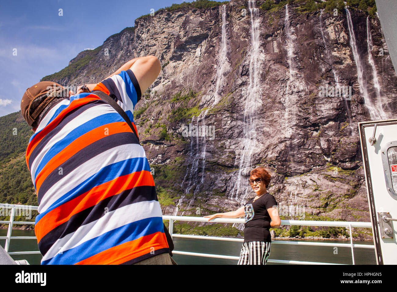 Tourists and waterfall Seven Sisters, Ferry between Geiranger and Hellesylt, Geirangerfjord, More og Romsdal, Norway Stock Photo