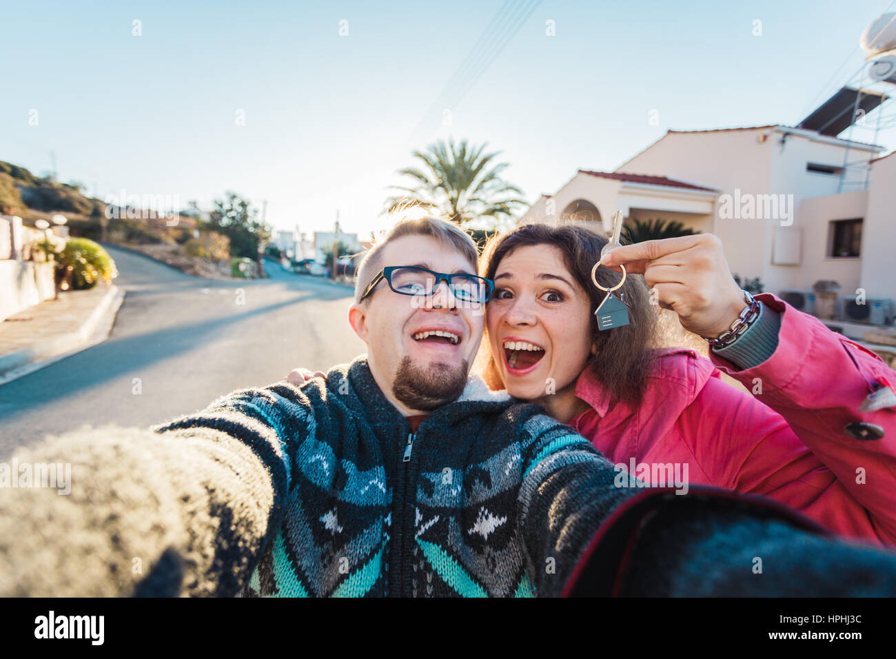 real estate: couple showing keys of their new house Stock Photo - Alamy
