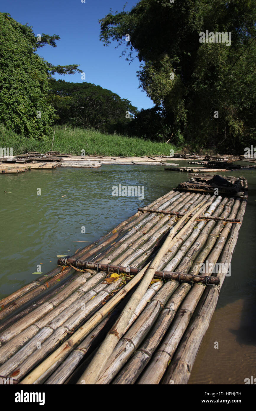 Bamboo rafts prepared & ready for a popular tourist day trip on the Martha Brae river, Falmouth, Jamaica. Close to Montego Bay & Ocho Rios. Stock Photo