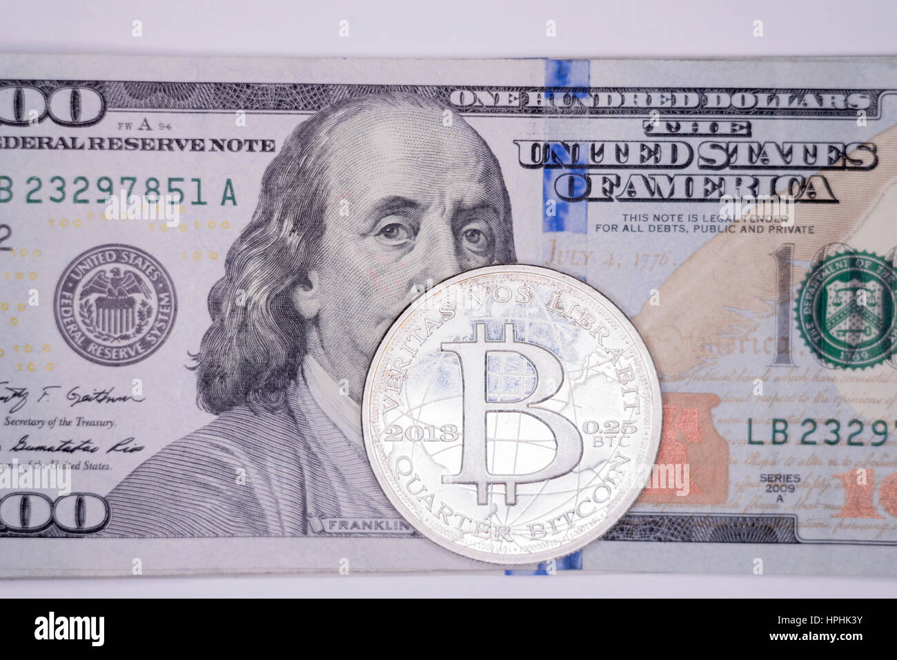 Bitcoin on 100 dollar bill background, gold coin of bitcoin on a hundred  dollar bill. Earnings on cryptocurrency mining Stock Photo - Alamy