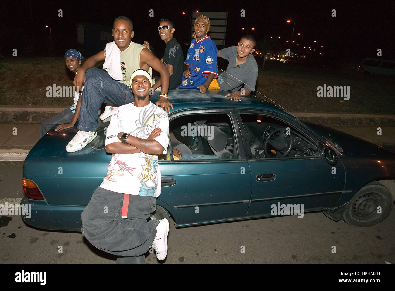 Mauritius, young Mauritians on the street waiting for admission in a disco, teenagers in front of their car, teenager, young men from Mauritius waitin Stock Photo