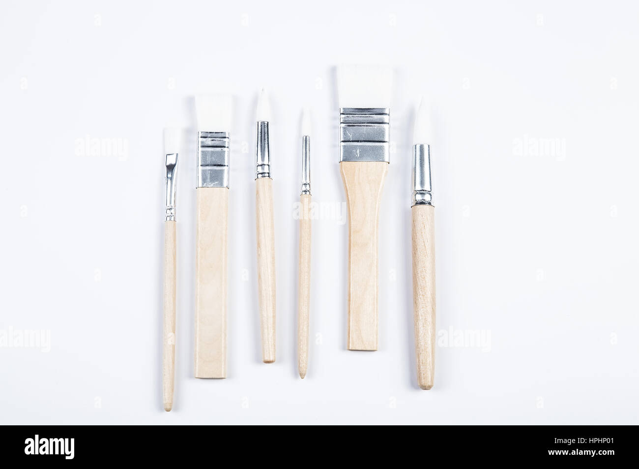 White paintbrushes with wooden handle isolated  background Stock Photo