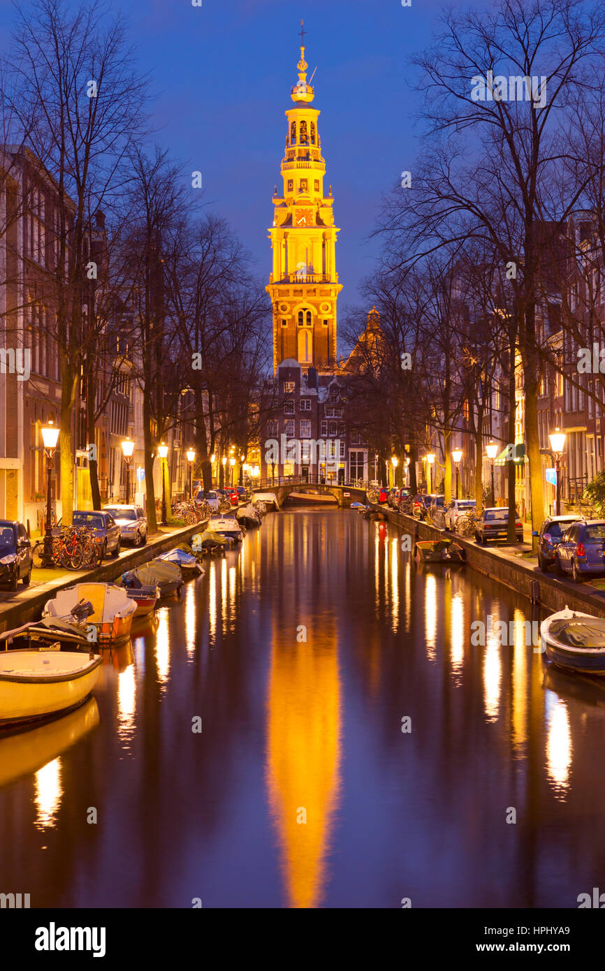 A church tower at the end of a canal in the city of Amsterdam, The Netherlands at night. Stock Photo