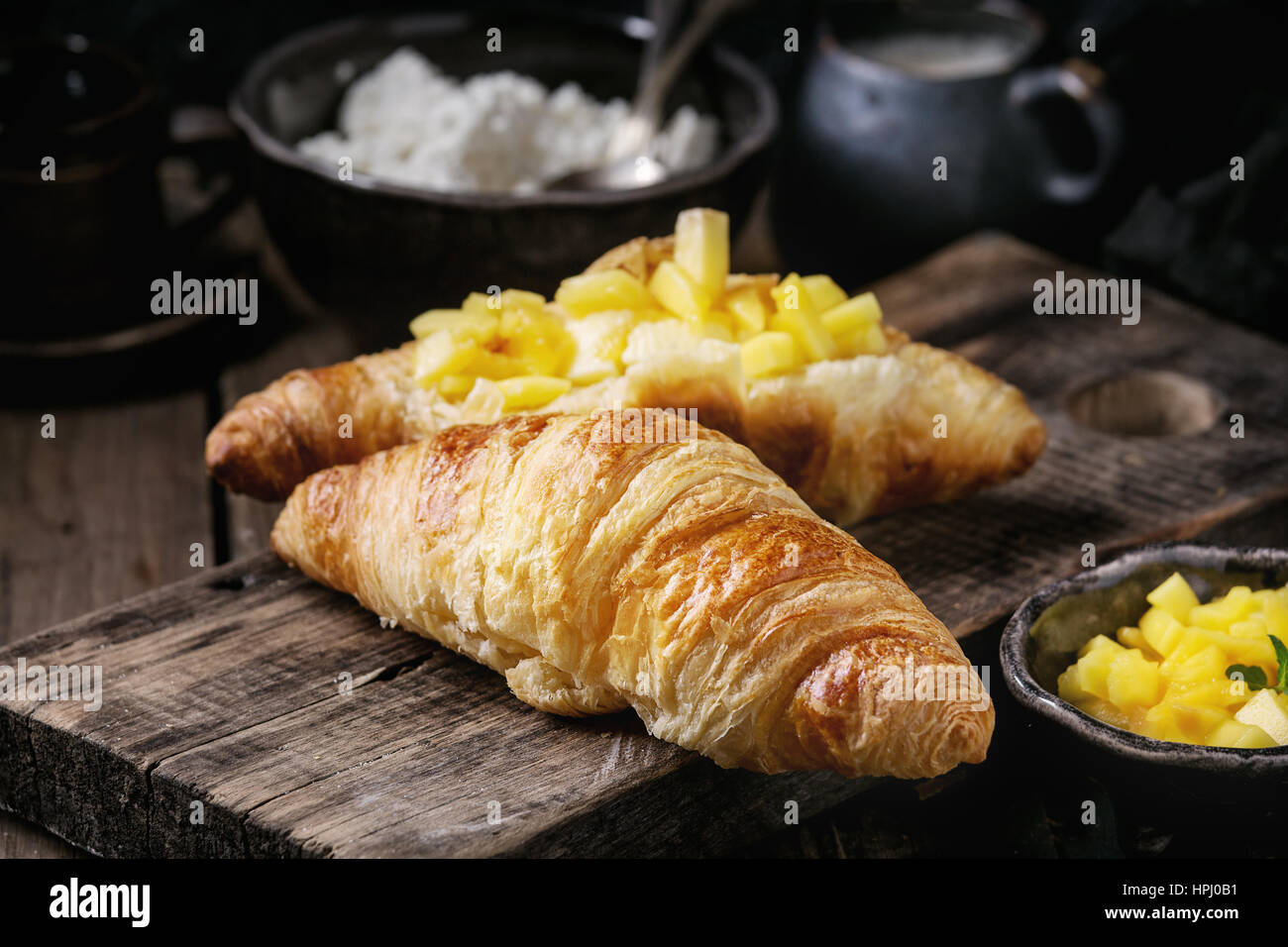Breakfast with croissant and mango fruit Stock Photo