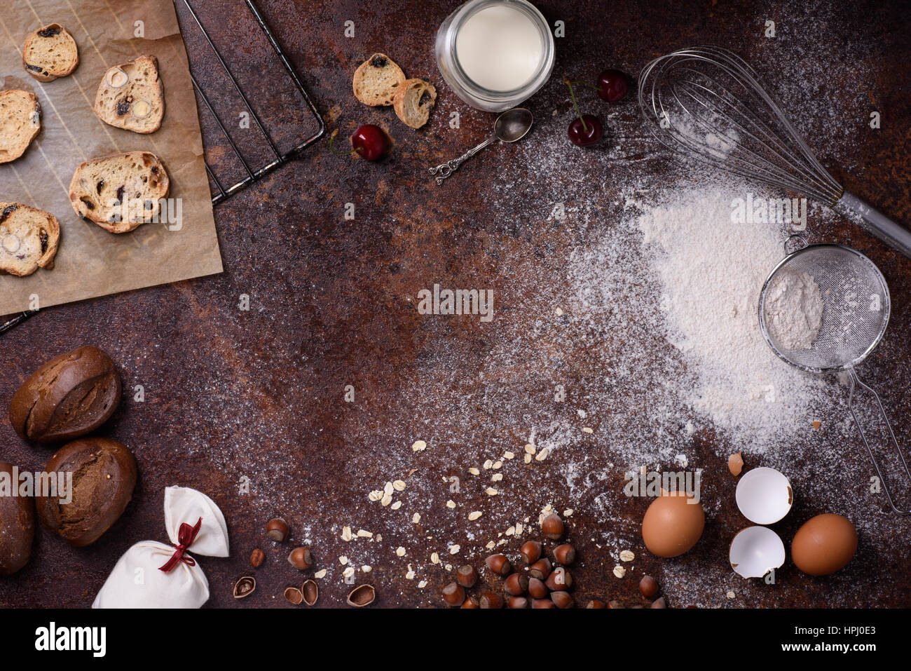 Bakery background, baking ingredients over rustic kitchen countertop. Baked  cookies with hazelnuts, rye bread, milk and eggs. Top view, copy space  Stock Photo - Alamy