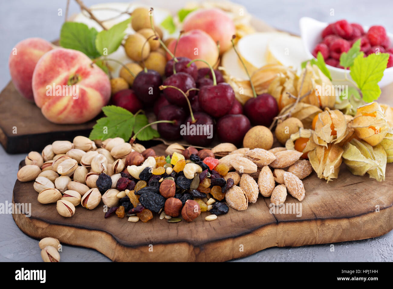 Fresh fruit and nut platter with cherry, peaches and trail mix Stock Photo Alamy