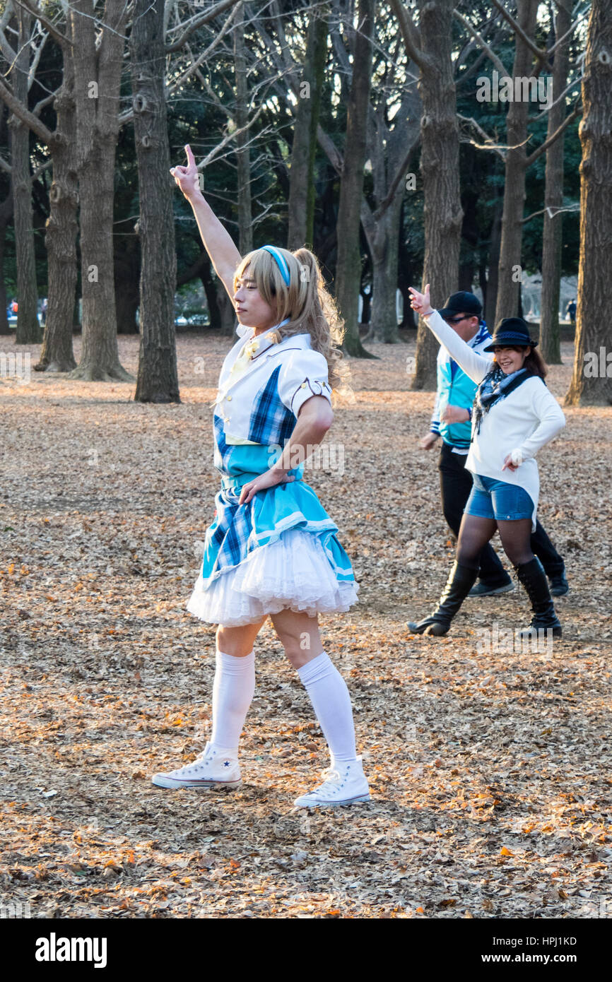 A male in female maid cosplay choreographing a dance routine in Yoyogi Park, Shibuya, Tokyo. Stock Photo