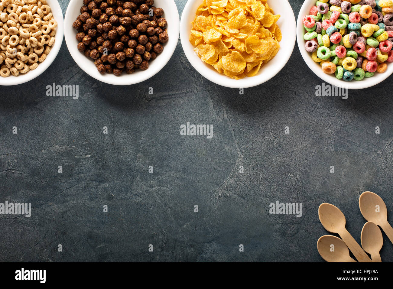 Variety of cold cereals in white bowls, quick breakfast for kids