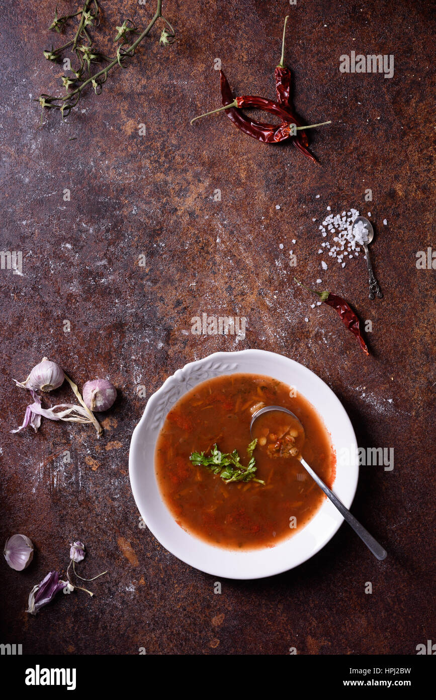 Gazpacho Spanish soup with ingredients on rustic background. Top view