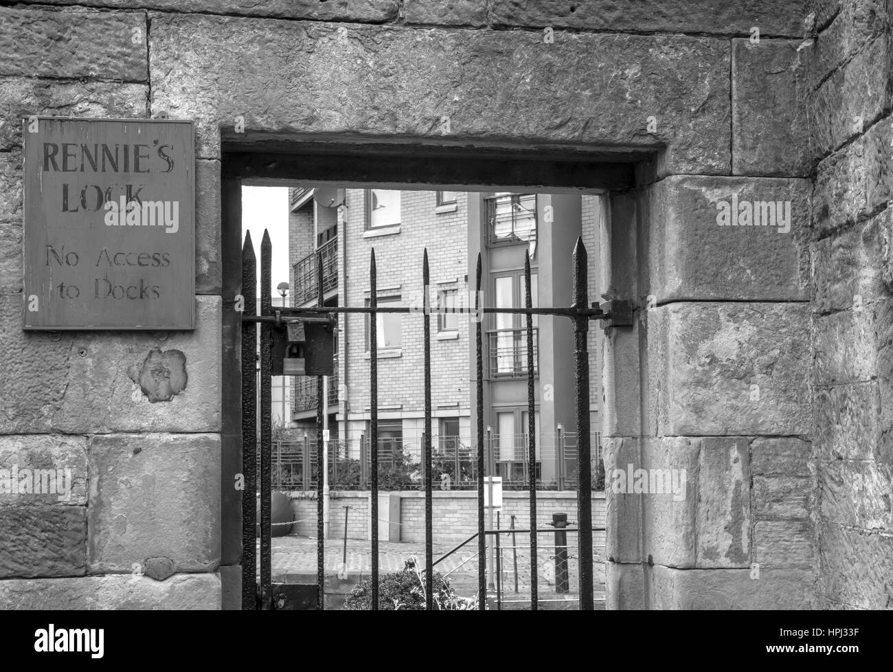 Old wrought iron gate with old sign for Rennie's Lock, Leith Harbour, Edinburgh, Scotland, at former Leith ferry terminal, UK Stock Photo