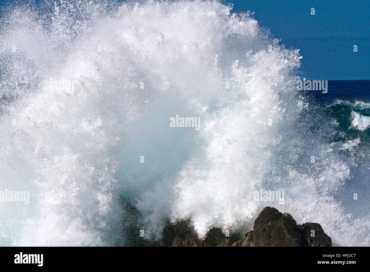 Waves crash along the rocky coast  on the Big Island of Hawaii, USA. Stock Photo