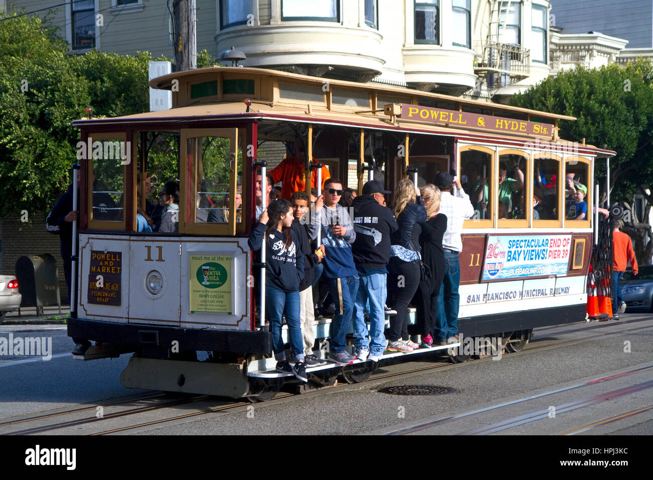 Passengers ride a cable car in San Francisco, California, USA. Stock Photo