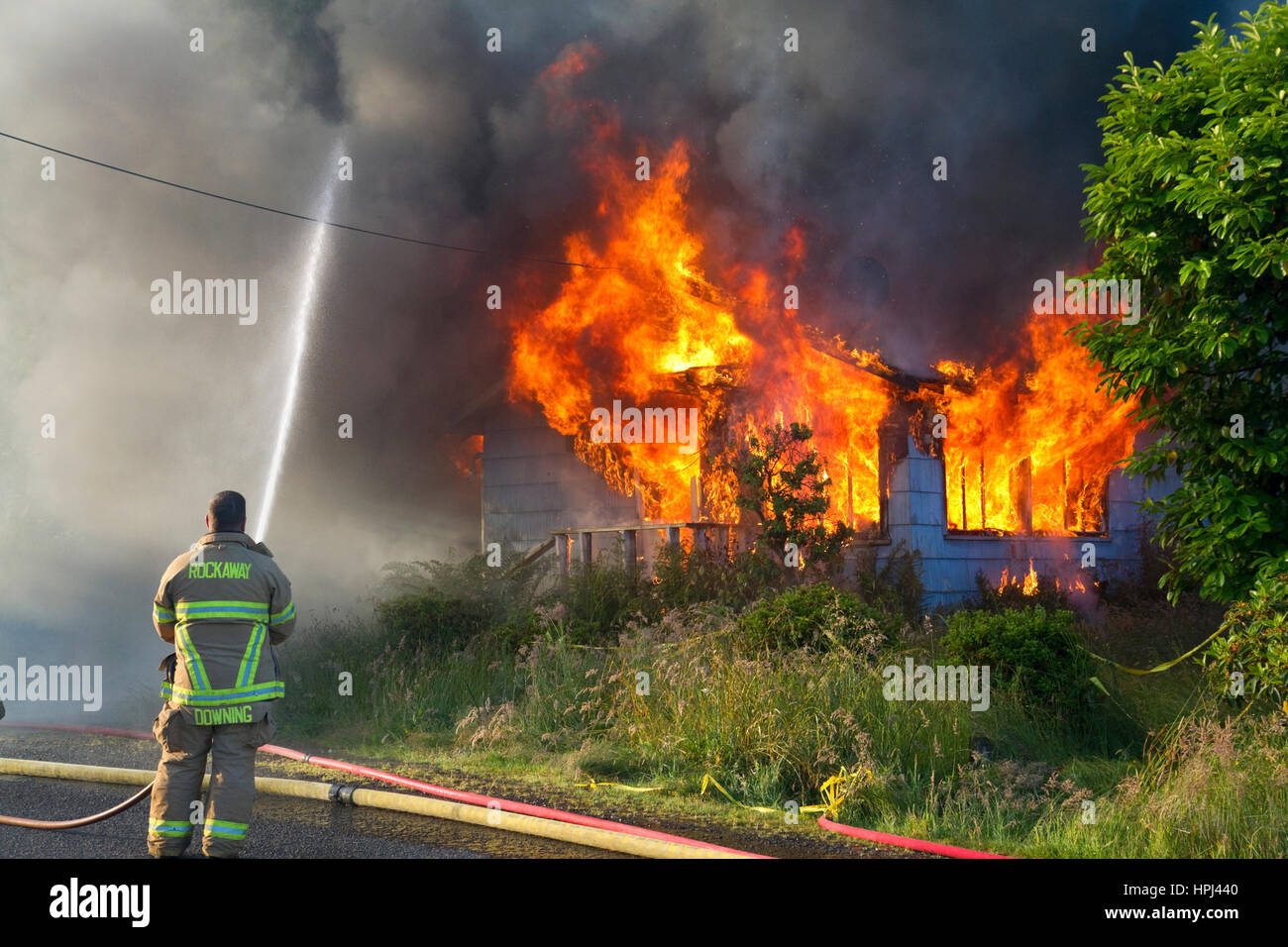 Firefighters working a training fire at Rockaway Beach, Oregon, USA. Stock Photo