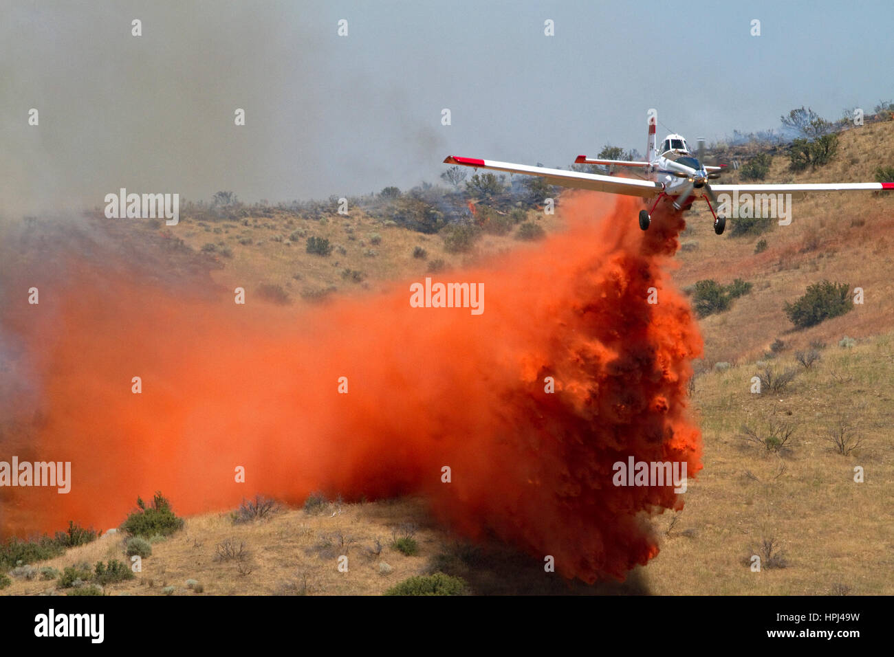 Single engine air tanker (SEAT) dropping fire retardant on a wildfire in Idaho, USA. Stock Photo