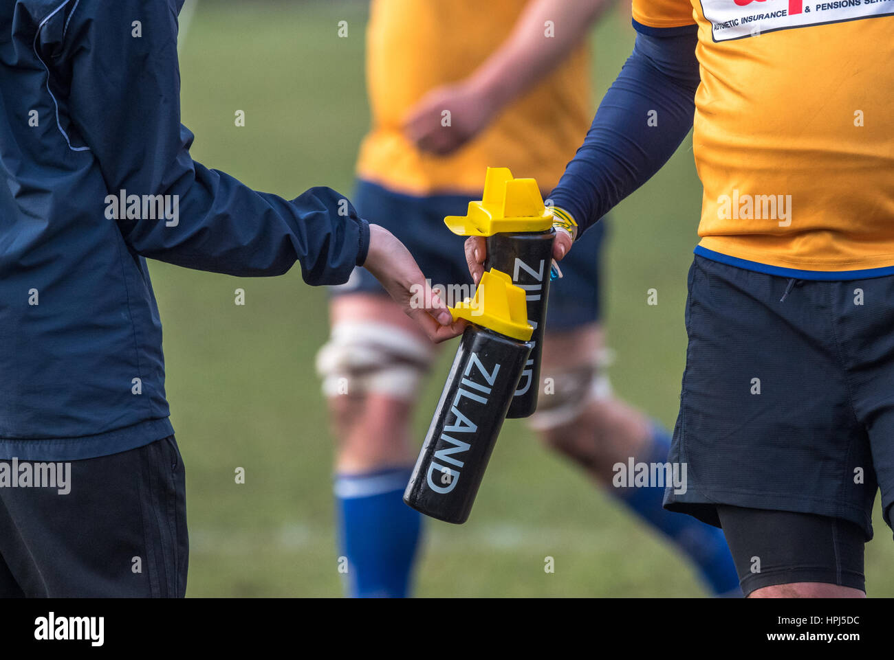 Rugby union player is handed liquids in a Ziland plastic bottle. Stock Photo
