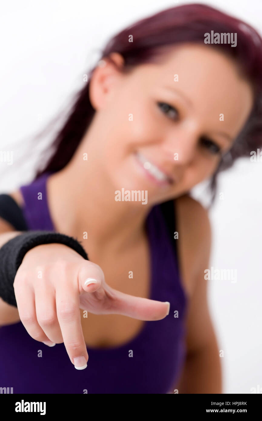 Model released , Sportliche, junge Frau zeigt mit Zeigefinger - sporty woman Stock Photo