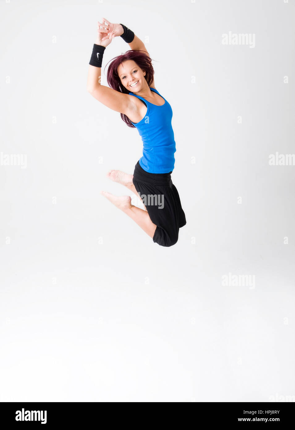 Model released , Sportliche, junge Frau springt - sporty woman jumping Stock Photo