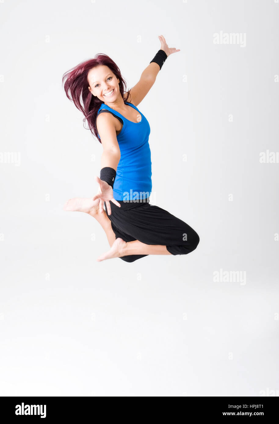 Happy sporty woman jumping hi-res stock photography and images - Alamy