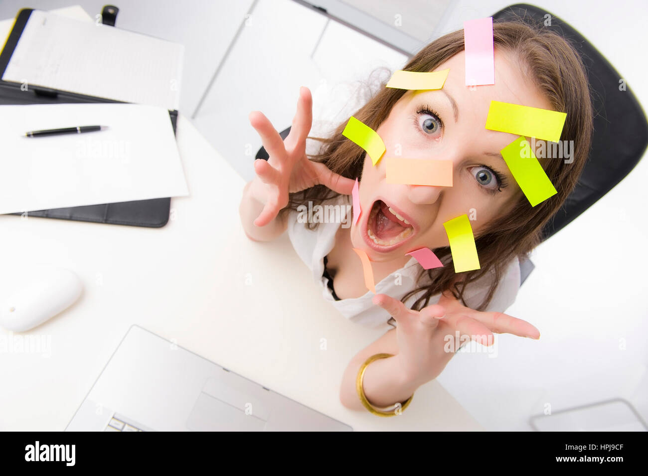 Model released , Bueroangestellte mit vielen Post-Its im Gesicht - clerk with many post-its on face Stock Photo