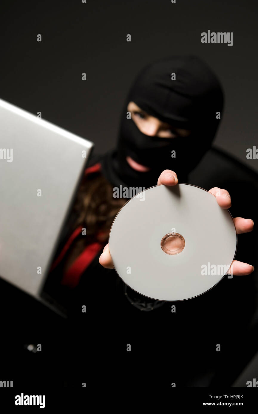 Model released , Einbrecherin mit CD - burglar with CD Stock Photo