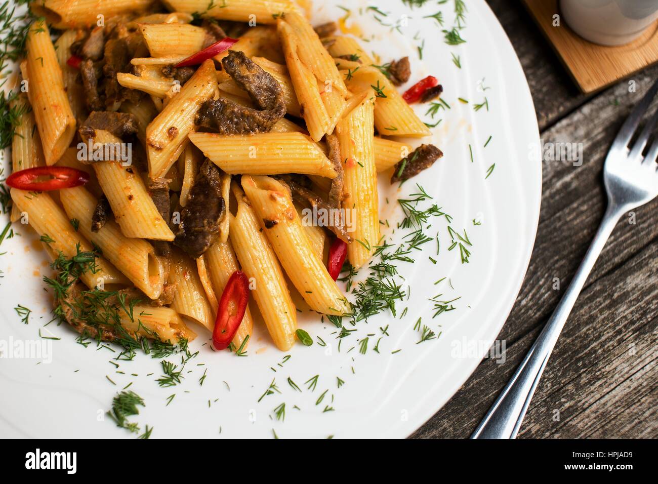 Tasty penne pasta recipe with beef meat. Italian pasta ala puttanesca
