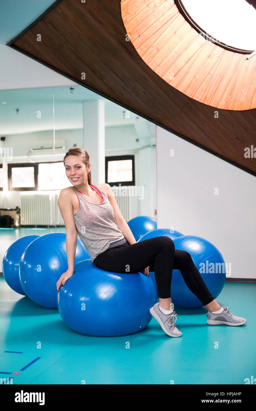 Young woman on pilates ball in the gym Stock Photo Alamy