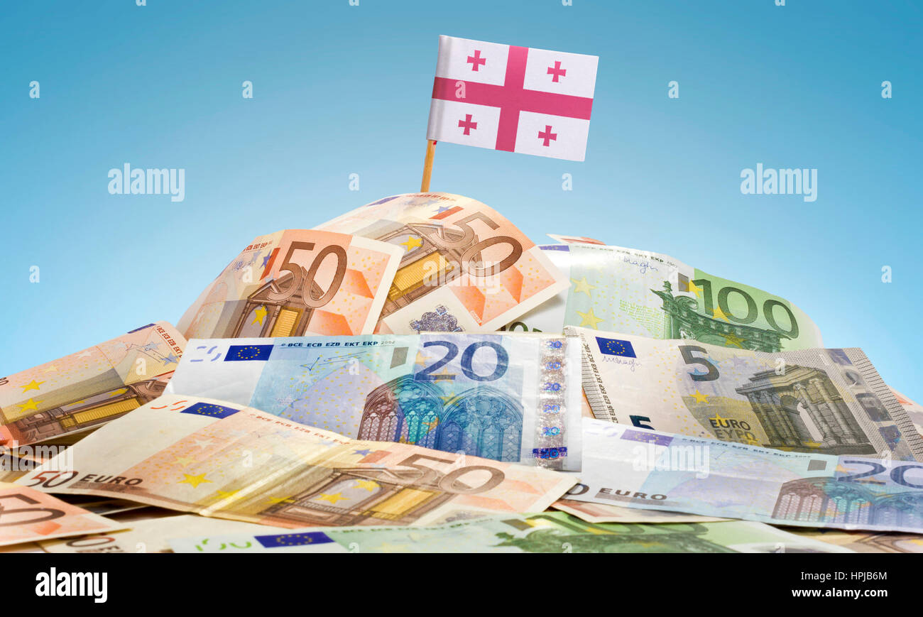 The national flag of Georgia sticking in a pile of mixed european banknotes.(series) Stock Photo