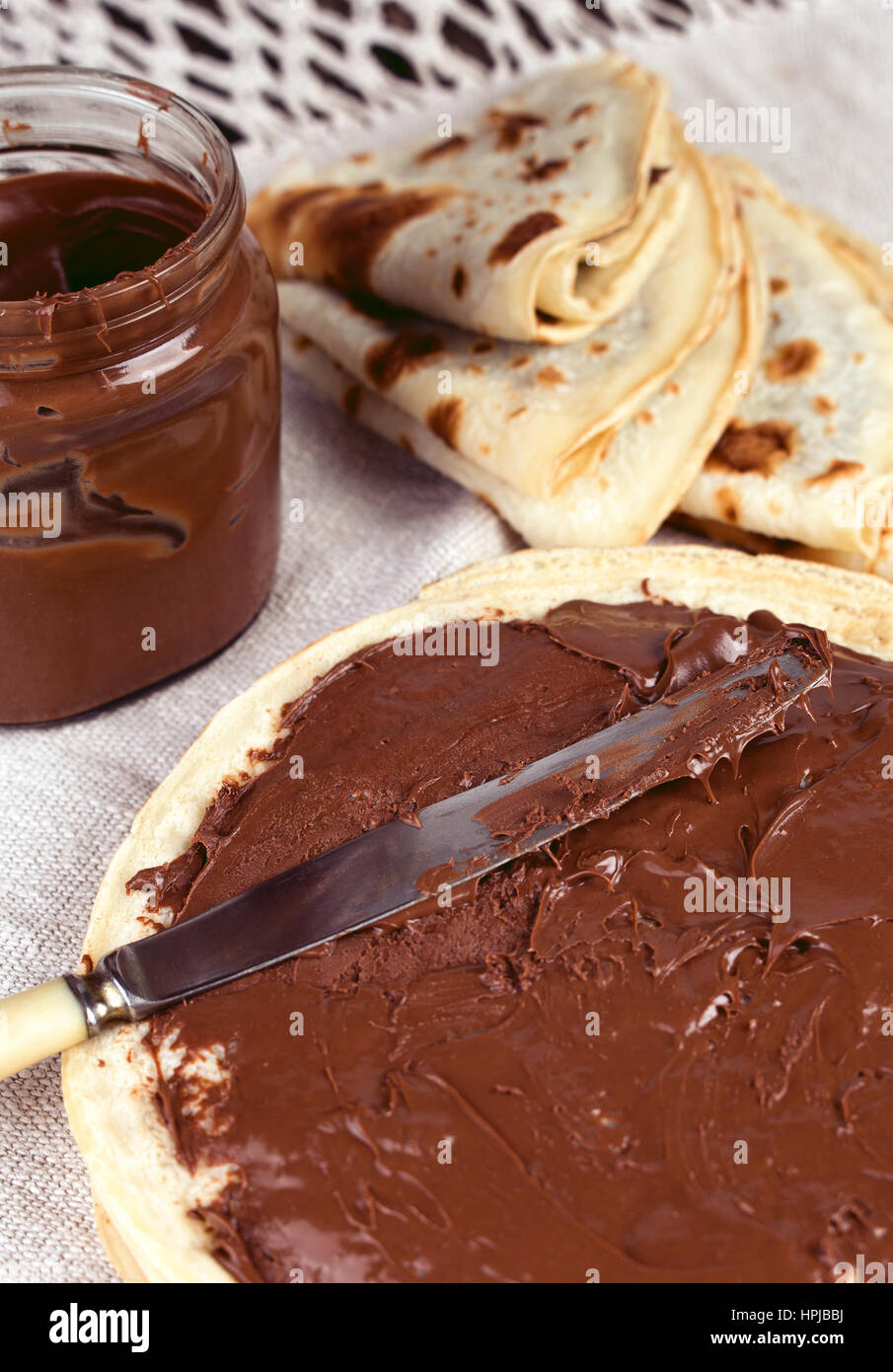 Delicious pancakes with nutella chocolate spread breakfast. Knife