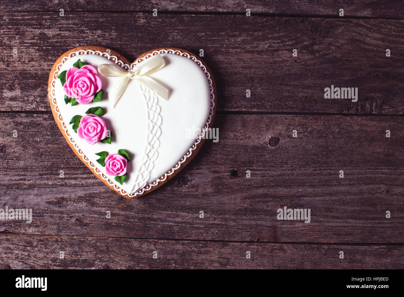 Heart shaped desert on wooden background. Present for a lover soulmate. Copy space. Stock Photo