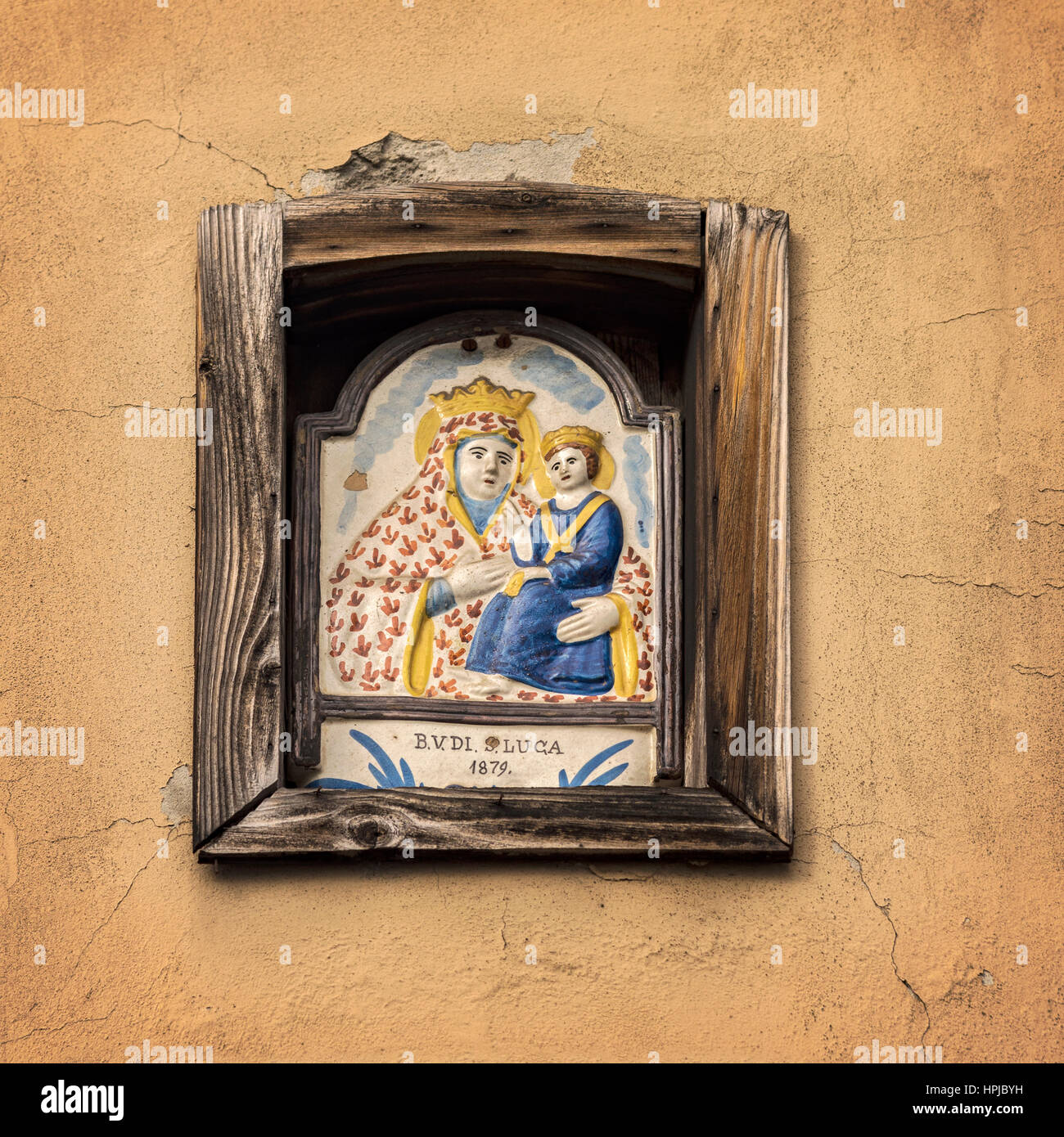 Image of a pictorial ceramic tile inside a building niche. Bologgna, Italy. Stock Photo