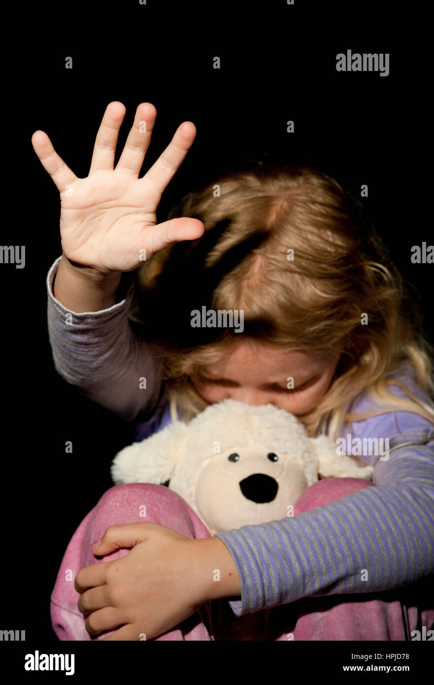Model released , Kind wehrt sich mit ausgestreckten Armen - girl resists someone Stock Photo