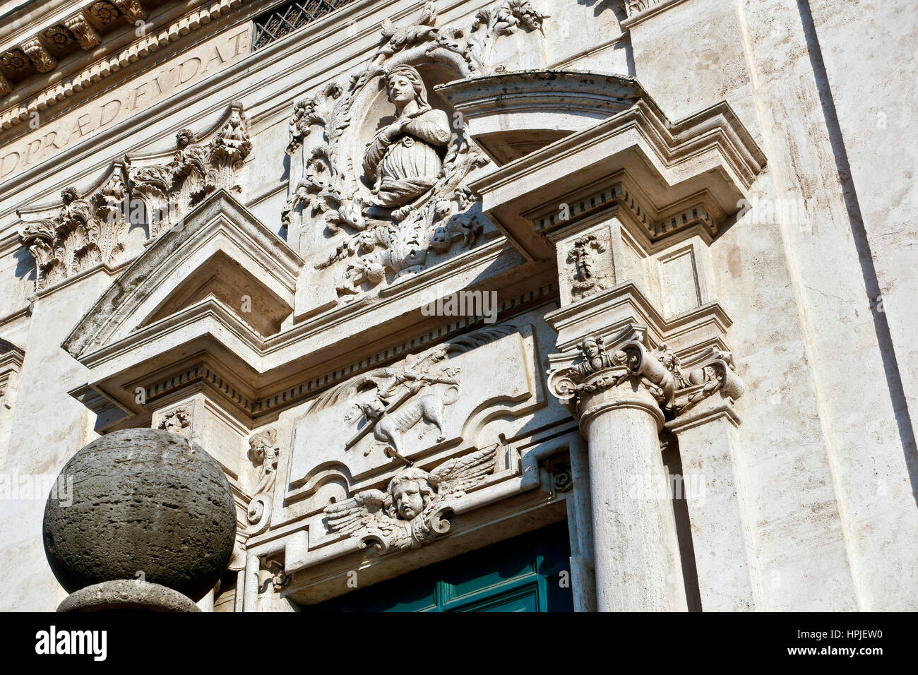 Close up of the baroque travertine facade of the Church of Saint Saints Dominic and Sixtus (Chiesa dei Santi Domenico e Sisto). Main door. Rome, Italy Stock Photo