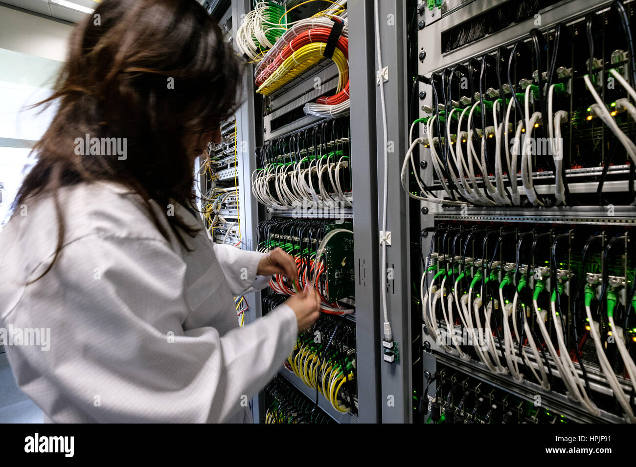 Data center technician working in the server room Stock Photo