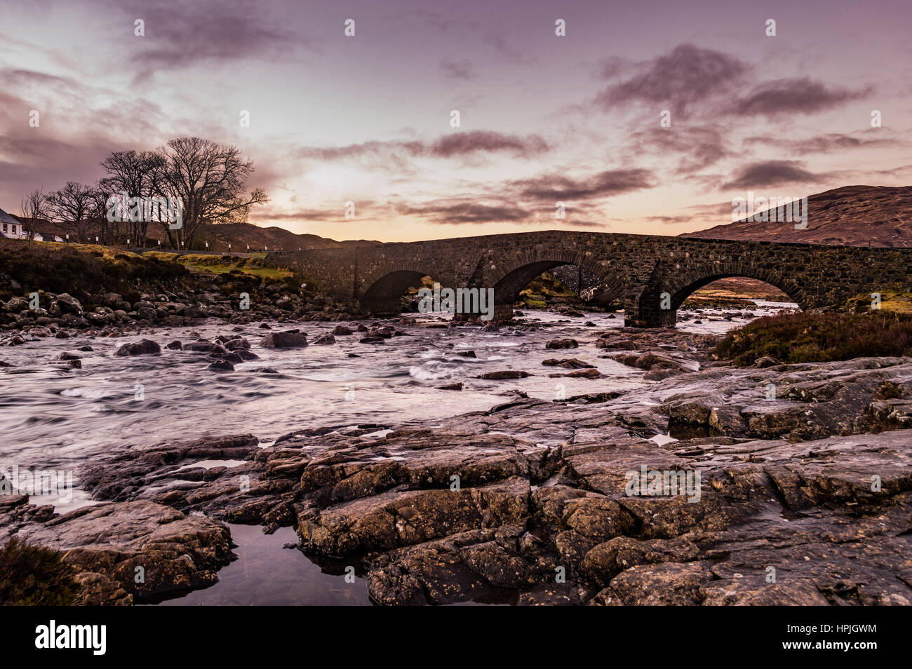 The Old Bridge at Sligachan, Isle of Skye, Scotland, with the sun setting during winter Stock