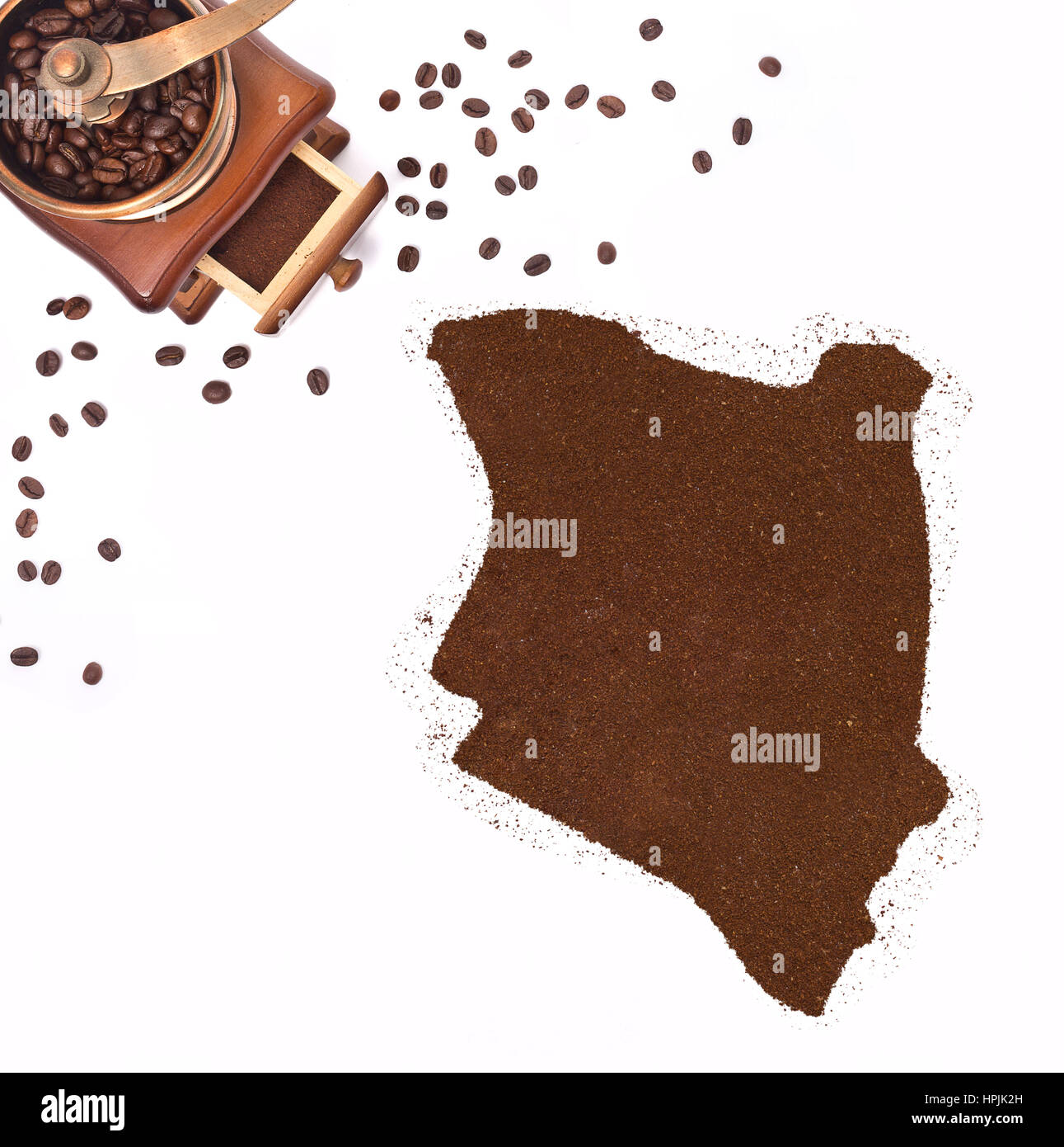 Coffee powder in the shape of Kenya and a decorative coffee mill