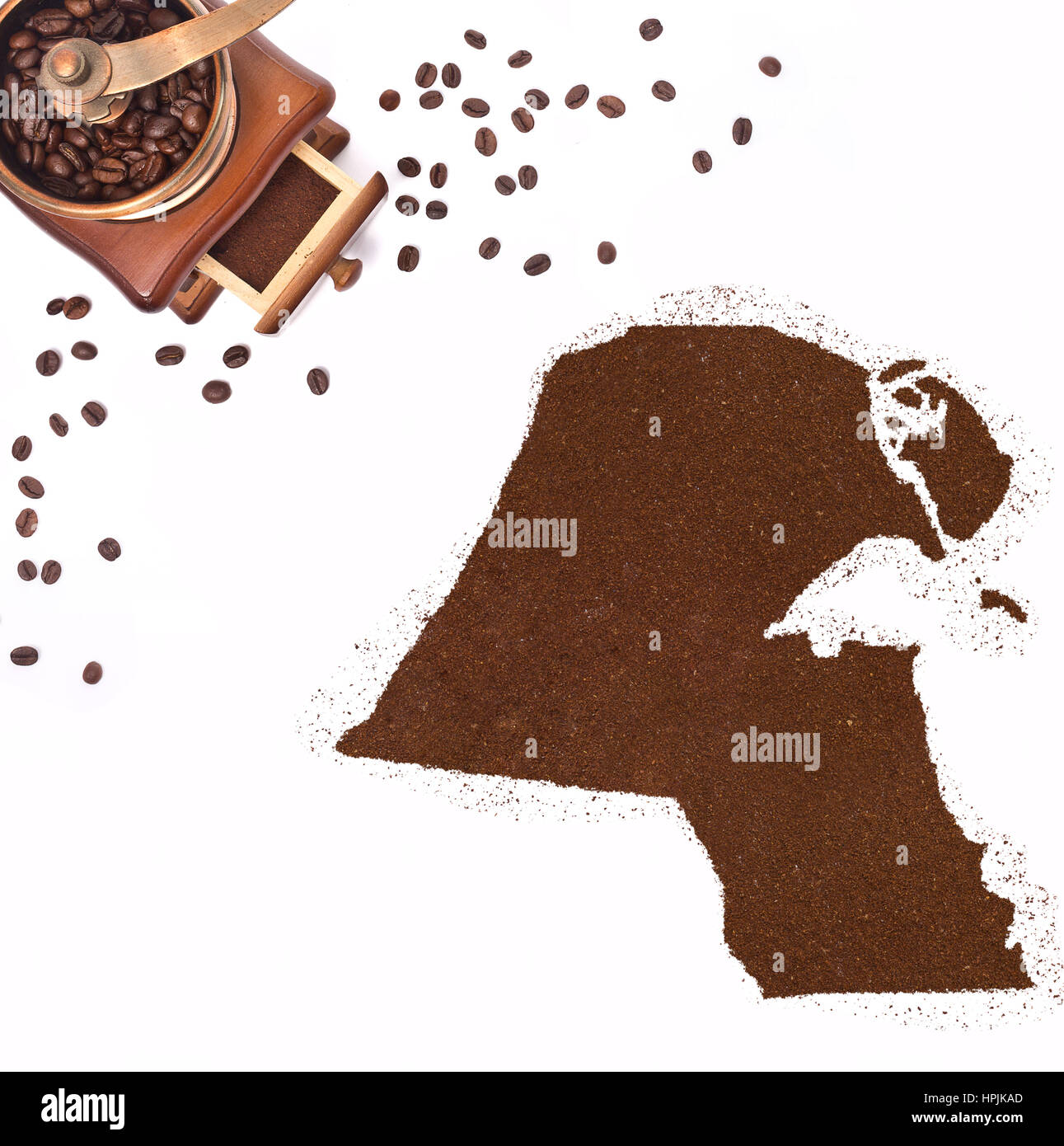 Coffee powder in the shape of Kuwait and a decorative coffee mill.(series) Stock Photo